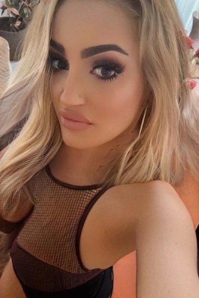 Roxi taking a selfie in a black dress.